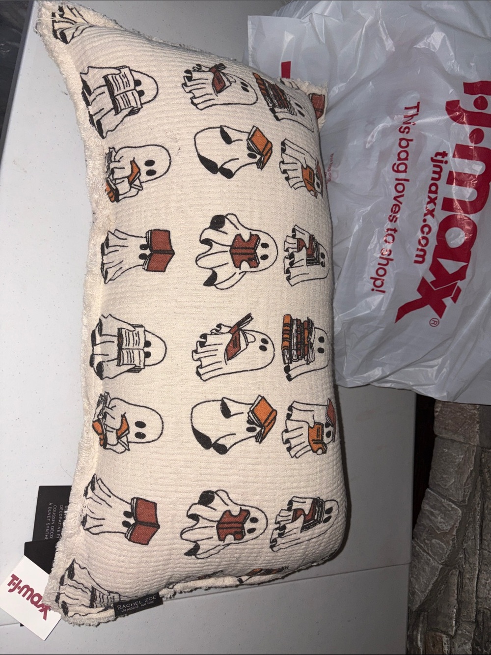 Rachel Zoe Cream reading Ghost Print Throw Pillow with Orange and Black Details